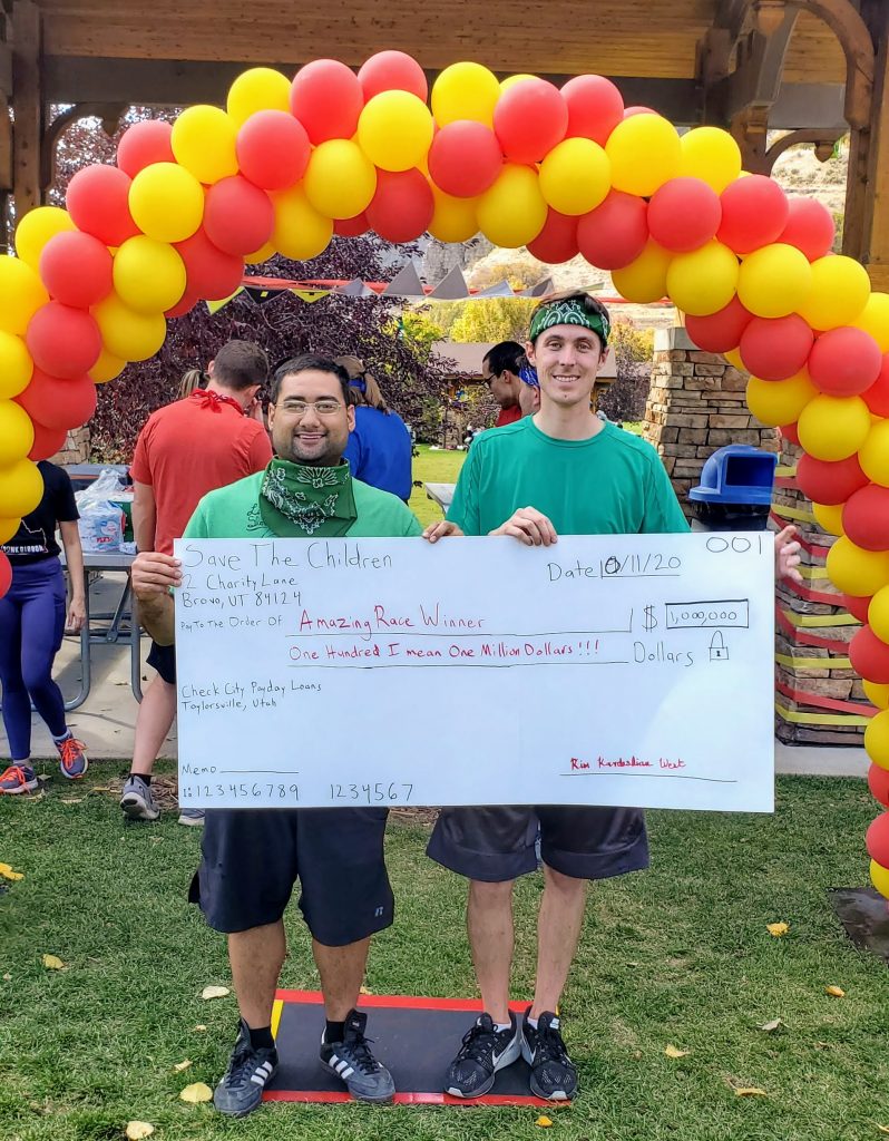 McKay and Zach holding a fake giant check as winners